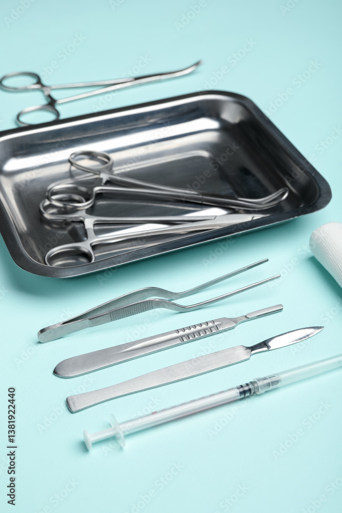 Different surgical tools on turquoise background, closeup Different surgical tools on turquoise background, closeup
