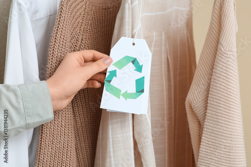 Woman holding recycling tag...