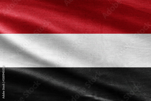 Yemen flag with waving fabric texture, horizontal red, white and black stripes, national patriotic symbol.