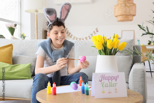 Teenage boy in bunny ears p...