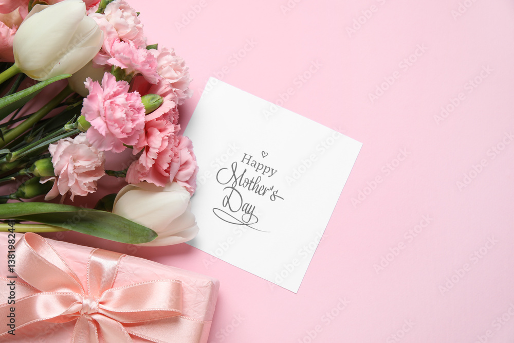 Bouquet of different beautiful flowers with greeting card and gift box on pink background. Mother's Day celebration