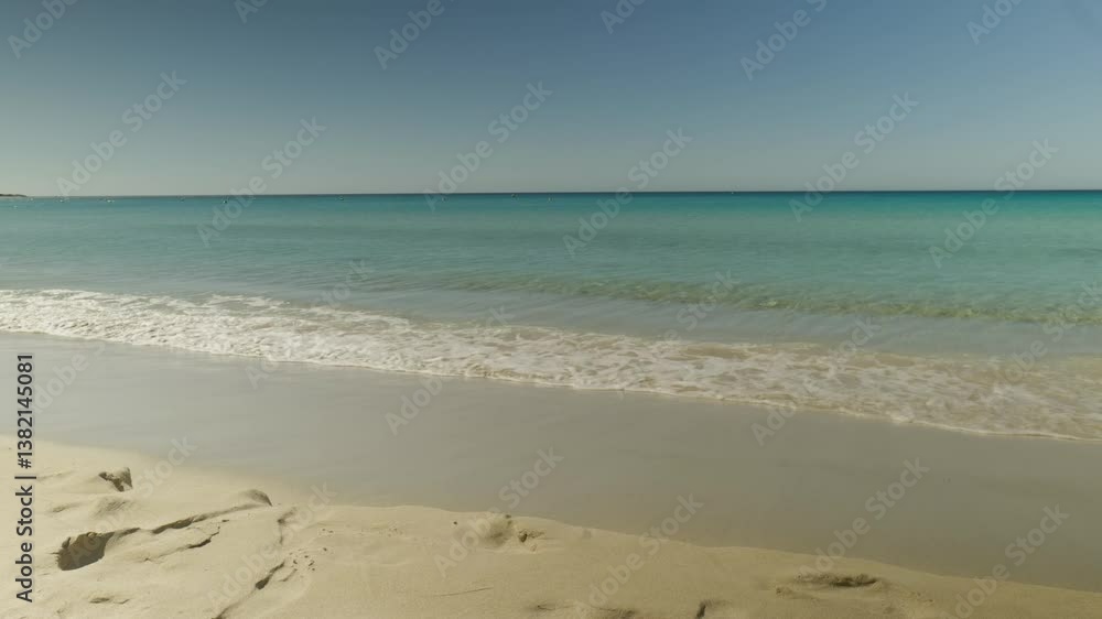 Crystal clear blue water crashing onto a sandy shore, showcasing the beauty of the coastline. Crystal clear blue water crashing onto a sandy shore, showcasing the beauty of the coastline.