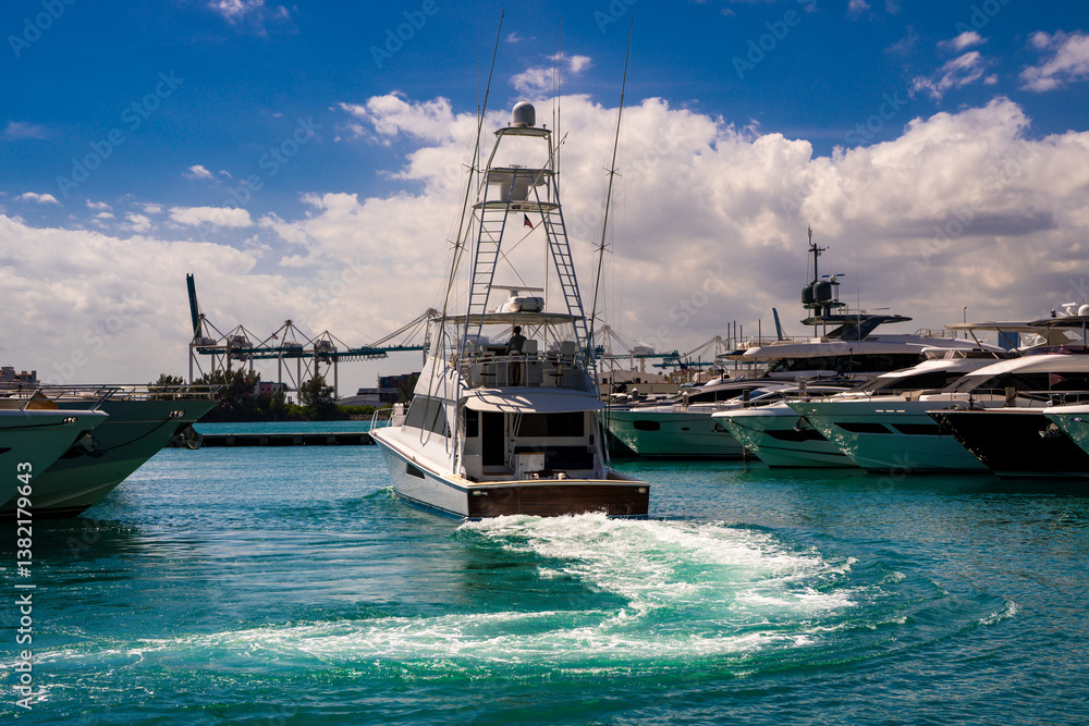 Naklejka premium Yacht sailing on sea waters. Luxury superyacht at sea. Miami Beach with yachts. Tropical seascape with a sailboat. Cruise ship near the coastline. Sunset yacht voyage in Florida. Yacht in ocean.