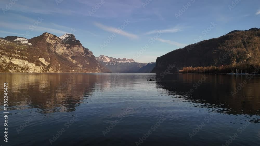 Drone flying over Lake Walen Walensee water reflection Switzerland mountain rural landscape Drone flying over Lake Walen Walensee water reflection Switzerland mountain rural landscape