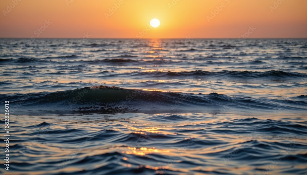 Obraz premium A calm ocean scene at sunrise, where light reflects off gentle waves, creating an ethereal glow across the water.