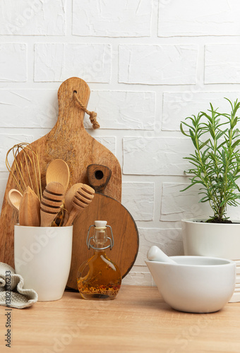 Obraz na płótnie Kitchen utensils and rosemary plant creating a cozy culinary scene w salonie