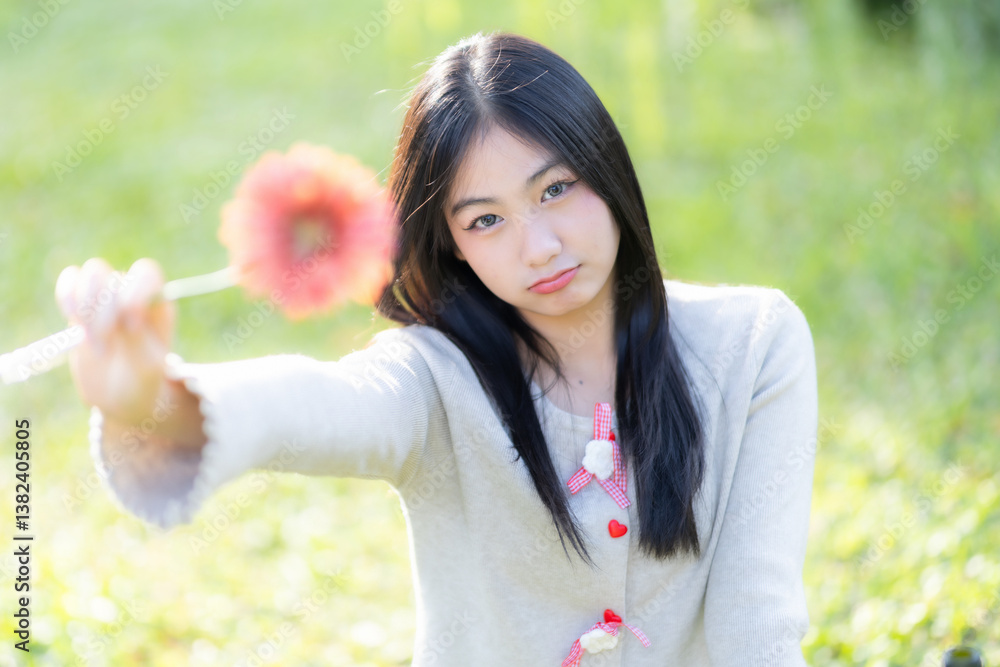 Portrait cute smiles Asian of attractive young teenage girl Holding flowers the cafe on vacation at a coffee shop in spring day