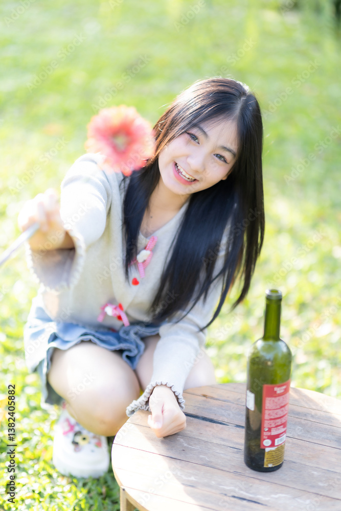 Portrait cute smiles Asian of attractive young teenage girl Holding flowers the cafe on vacation at a coffee shop in spring day