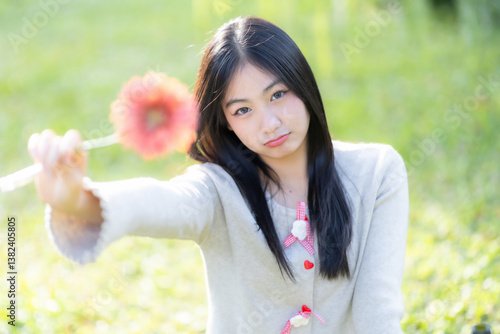 Obraz na płótnie Portrait cute smiles Asian of attractive young teenage girl Holding flowers the cafe on vacation at a coffee shop in spring day w salonie