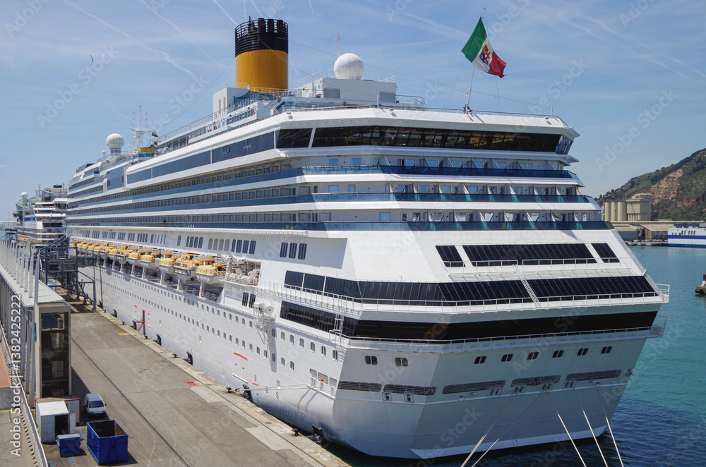Modern family cruiseship Pacifica and other cruise ship liners in port of Barcelona, Spain on sunny summer day seen from landside during Mediterranean cruising