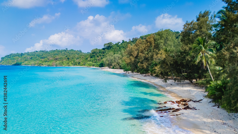 Fototapeta premium Experience a breathtaking aerial shot of Koh Kood Island, Thailand, beautifully showcasing its pristine beach, shimmering turquoise waters, and verdant lush tropical foliage all around