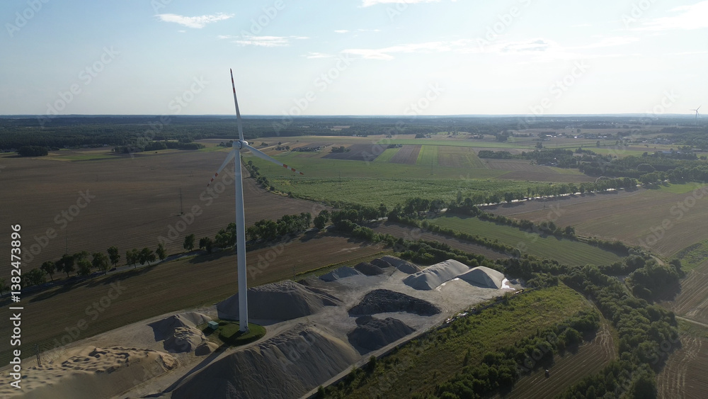 Wind turbine in sunset sky background