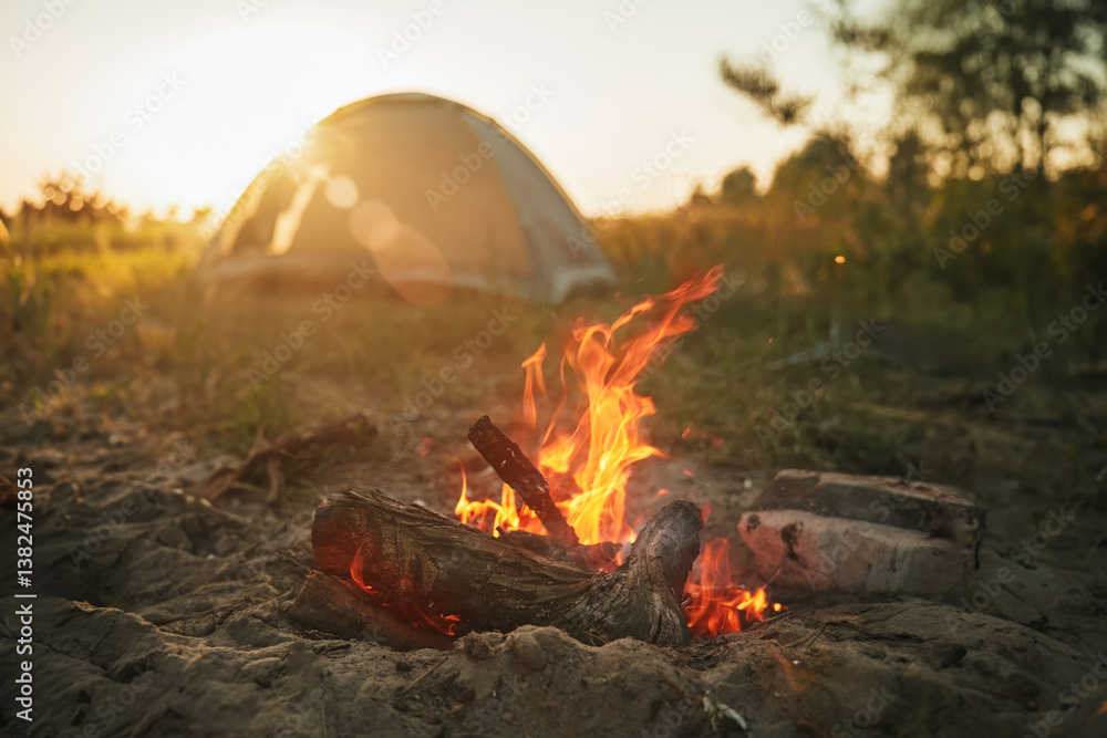 Evening campfire in front of a tent in the wilderness
