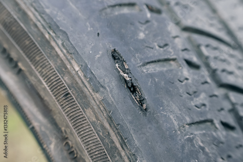 Damaged car tire showing surface wear and tear