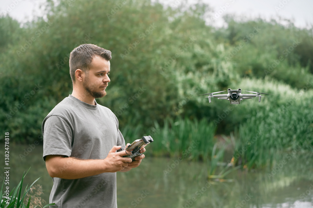 Smiling man piloting drone with visual line.