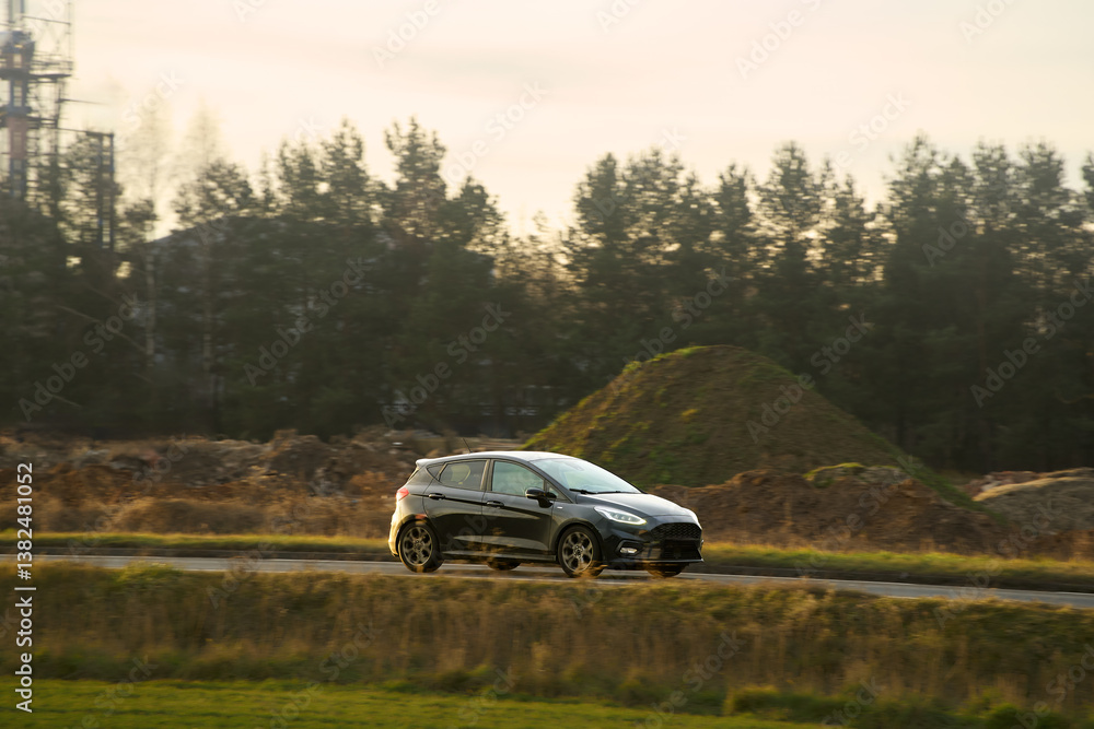 Eco-friendly car in motion on country road