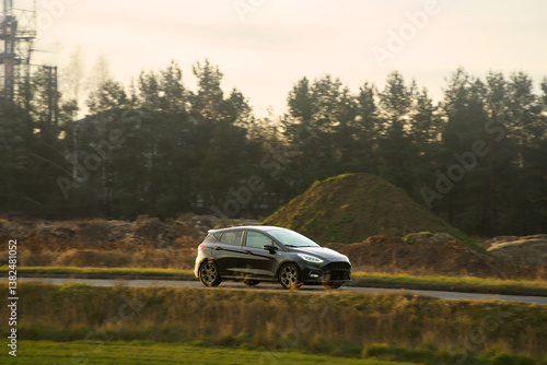 Obraz na płótnie Eco-friendly car in motion on country road w salonie