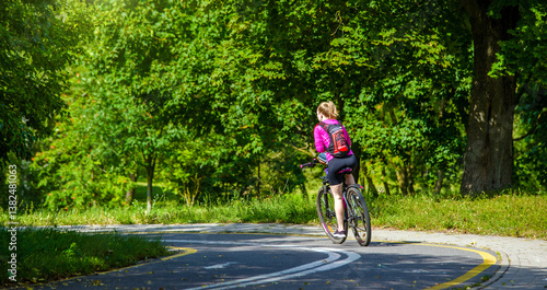 Wallpaper Mural Cyclist ride on the bike path in the city Park
 Torontodigital.ca