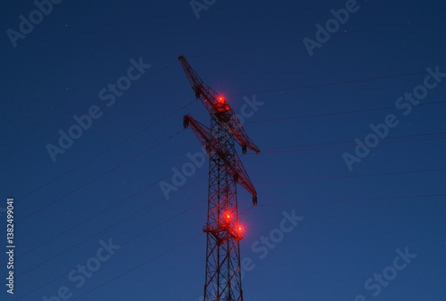 Power line with red lights at dusk in the Netherlands