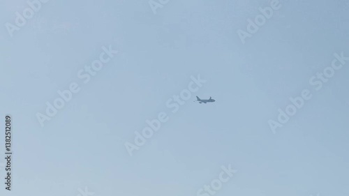The plane flies in the blue sky