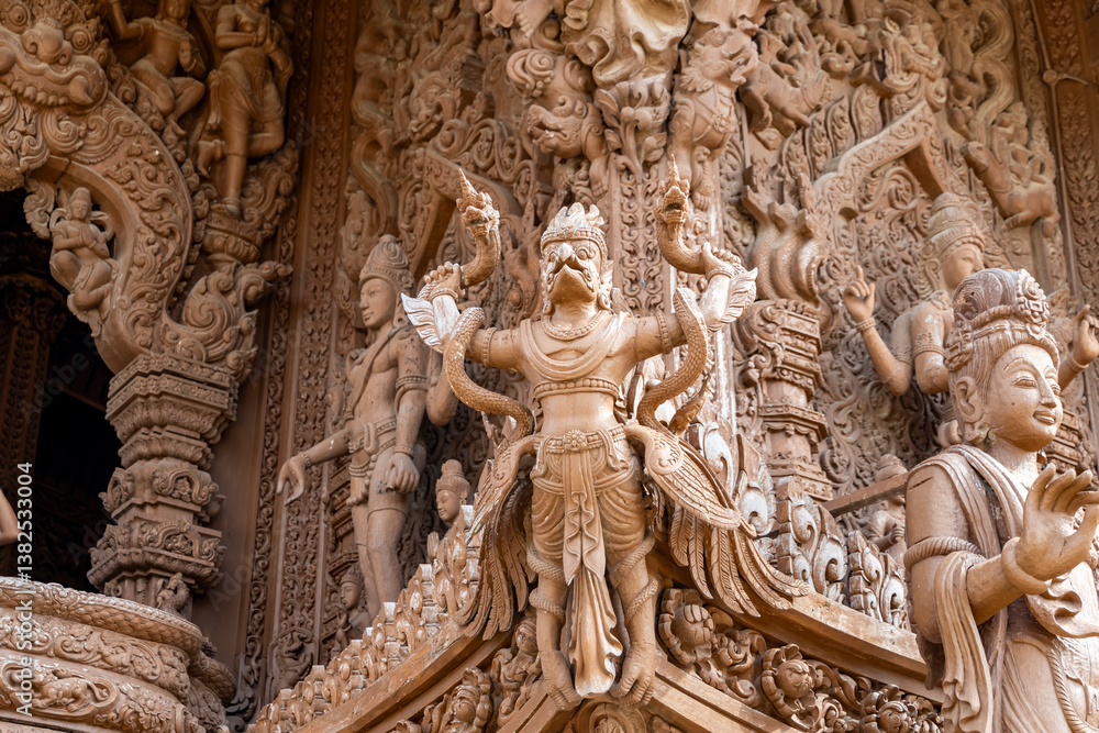 Fototapeta premium The intricate wooden architecture of the Temple of Truth in Pattaya,Thailand.The temple features ornate carving and statues,with a detailed root structure and multiple spires.outside view