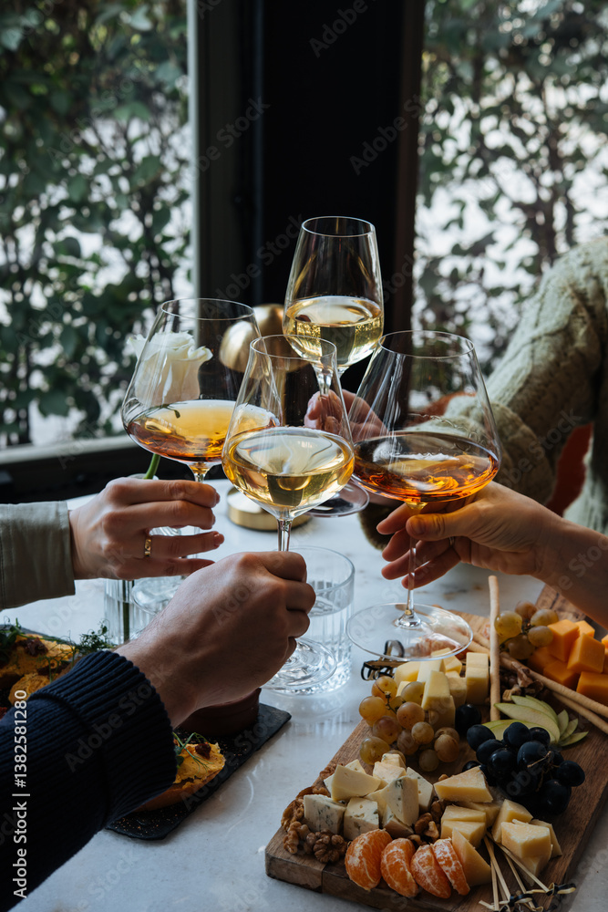 Friends having a dinner party with different kinds of appetizers and wine.