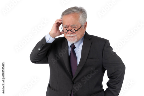 A confused senior Asian businessman in a dark suit, scratching his head and wearing glasses, standing against isolated on a transparent background, projecting a sense of puzzlement and contemplation