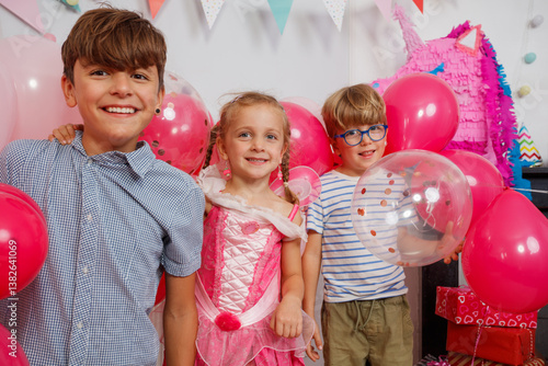 Obraz na płótnie Joyful kids enjoying a festive day with balloons and laughter w salonie