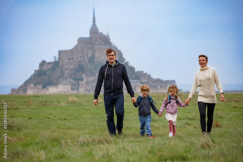 Smiling family enjoy Mont Saint-Michel's iconic scenery together