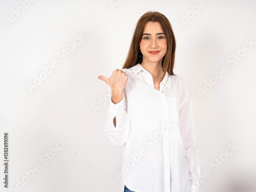 Caucasian young girl wearing white shirt holds hands under chin, glad to hear heartwarming words from stranger