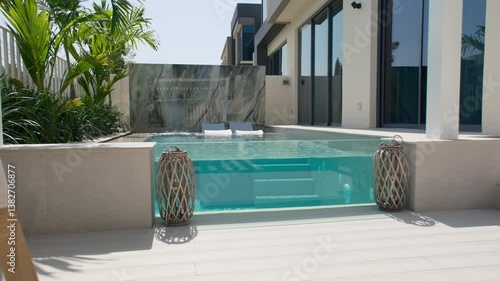 A small private swimming pool in the backyard of a luxury villa in Dubai on a sunny day