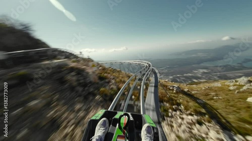 Ride on alpine coaster in Montenegro, first person view in summer sunny day. 