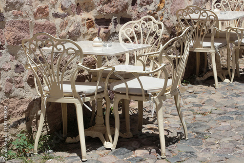 vivid photographs in nature taken on summer day on Cunda Island. White, ecru, cream colored chairs, doors, walls. Vintage designs for restaurants, cafes in touch with nature.