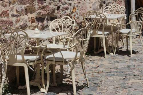 vivid photographs in nature taken on summer day on Cunda Island. White, ecru, cream colored chairs, doors, walls. Vintage designs for restaurants, cafes in touch with nature.