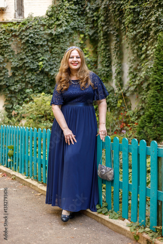 Obraz na płótnie Woman in a long blue dress in the garden. w salonie
