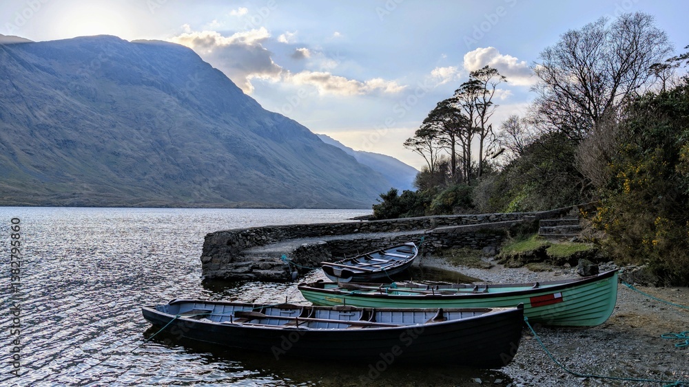 Obraz premium Lakeside landscape scenery, old wooden fishing boats at Doo lough, Delphi valley, county Mayo, Ireland, nature and mountains background