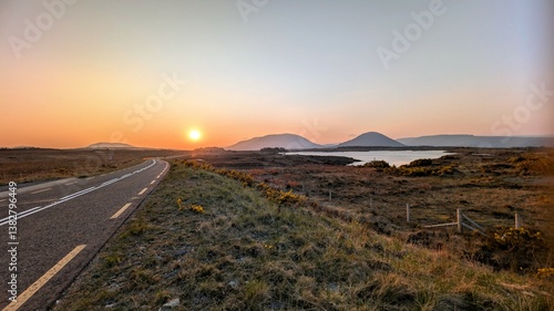 Beautiful sunset landscape scenery, empty road with mountains in background at Connemara national park, county Galway, Ireland