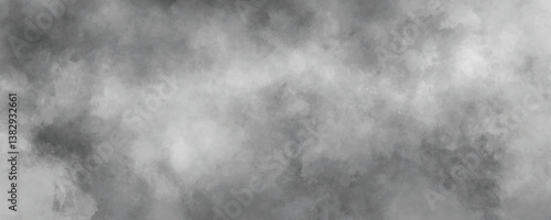 Dark and moody cloudy abstract background with soft blended ink wash patterns

