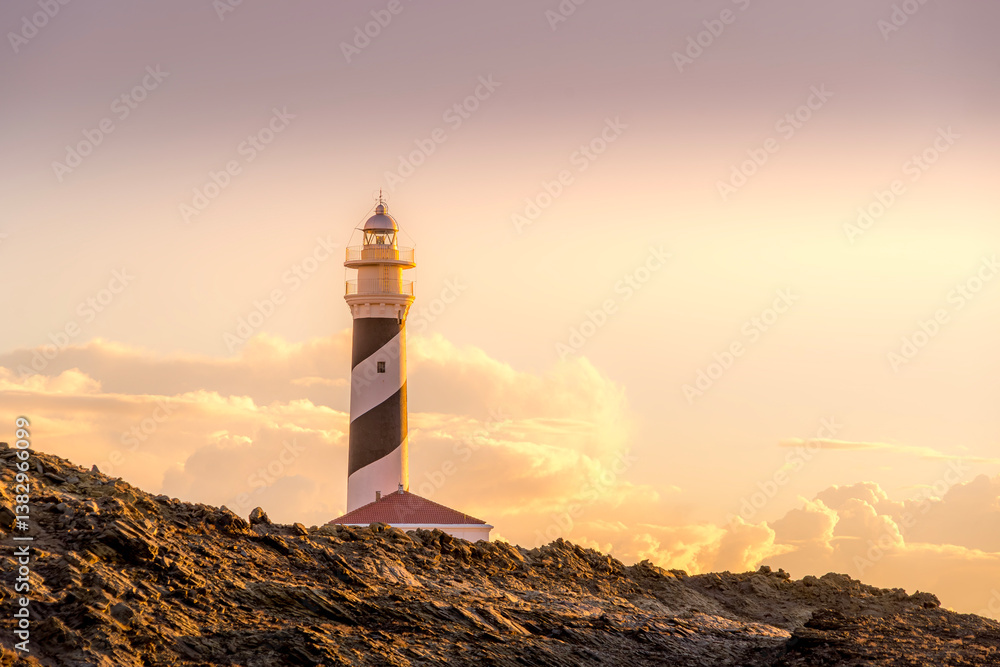 A captivating view of Lighthouse Favaritx in Menorca during the golden hour, showcasing the lighthouse's striking presence against a backdrop of warm sunset hues.