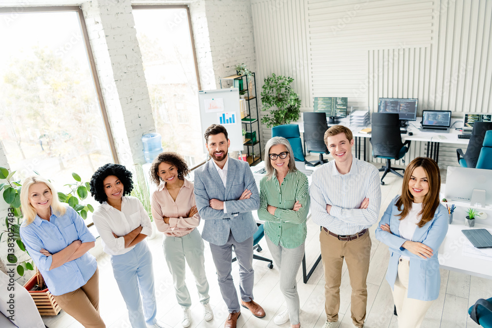 Obraz premium Diverse business team standing together in a modern office environment, multi-age