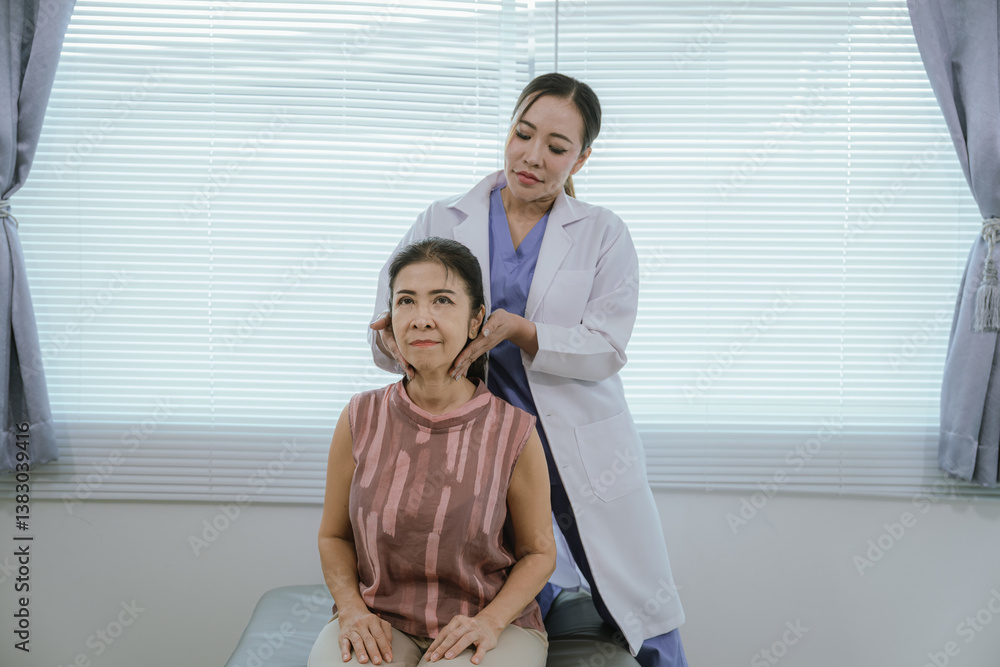 Fototapeta premium A female doctor is giving physical therapy to an elderly woman.