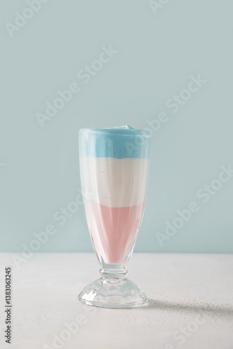 Obraz na płótnie Patriotic layered cocktail for Independence Day in color USA flag on blue background. Food for 4th of July or Memorial Day. Vertical format. w salonie