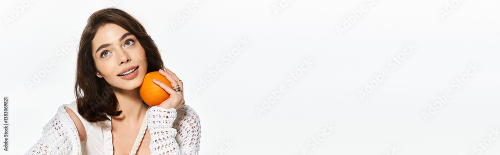 Bright summer vibes with a fashionable young woman holding an orange in a stylish outdoor setting Bright summer vibes with a fashionable young woman holding an orange in a stylish outdoor setting