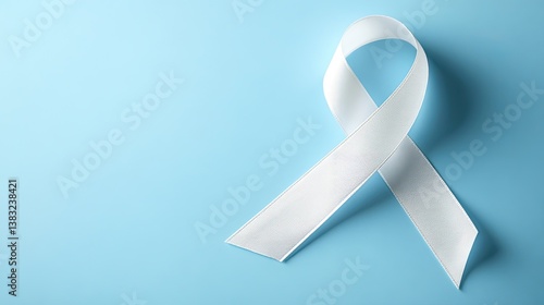 White ribbon as symbol of woman violence or lung cancer on blue background. November awareness lung cancer month, disease help support.