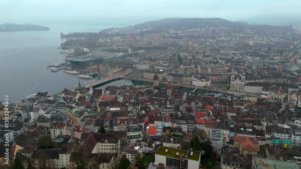 Aerial view of Lucerne Musegg Wall and towers shrouded in morning fog, overlooking River Reuss. Misty atmosphere, historical ambiance, blending nature with Swiss heritage. Museggmauer, Luzern, Schweiz Aerial view of Lucerne Musegg Wall and towers shrouded in morning fog, overlooking River Reuss. Misty atmosphere, historical ambiance, blending nature with Swiss heritage. Museggmauer, Luzern, Schweiz