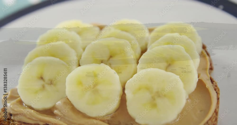 Banana slices on peanut butter toast over scenic landscape animation Banana slices on peanut butter toast over scenic landscape animation