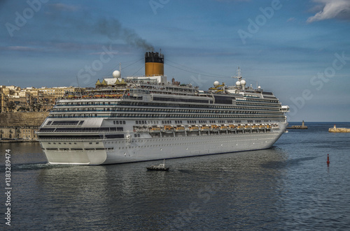 Obraz na płótnie Gigantic cruiseship cruise ship liner Fascinosa docked at pier terminal in old town Valletta, Malta with historic buildings, city skyline and harbor entrance w salonie