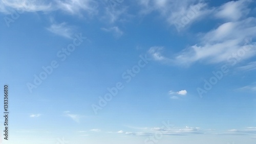 Light Blue Vault of Heaven, Filmy Clouds Wandering. The light blue sky is pure and vast. A few filmy clouds float leisurely, as if dancing gently, adding a touch of leisure and agility to the boundles