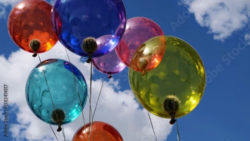 Wallpaper Mural Colorful transparent balloons with small cacti attached to them are floating against a vibrant blue sky with fluffy white clouds, creating a whimsical and surreal scene Torontodigital.ca