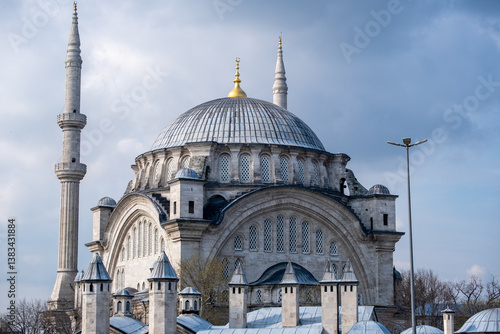 Süleymaniye Mosque in Istanbul: Historic Ottoman Architecture with Minarets, Dome, Arches, Stone, and Crescent under a Cloudy Sky in Turkey.